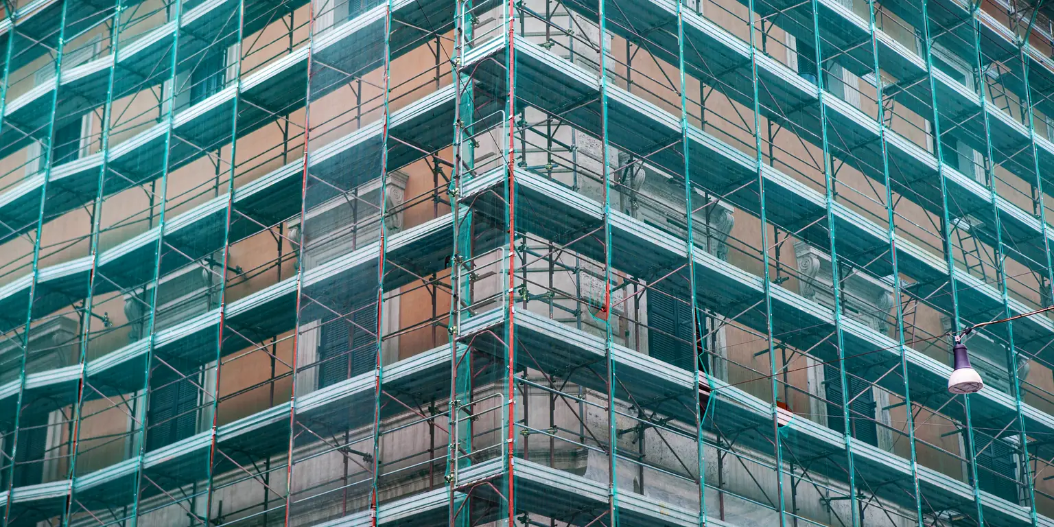 Brick elevation under construction with scaffolding across the facade