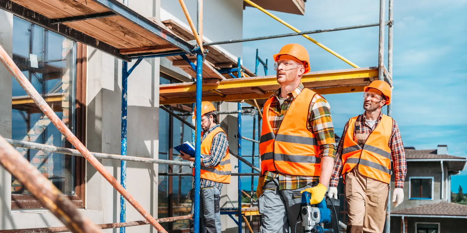Main contractor at work on a scaffolded building under construction
