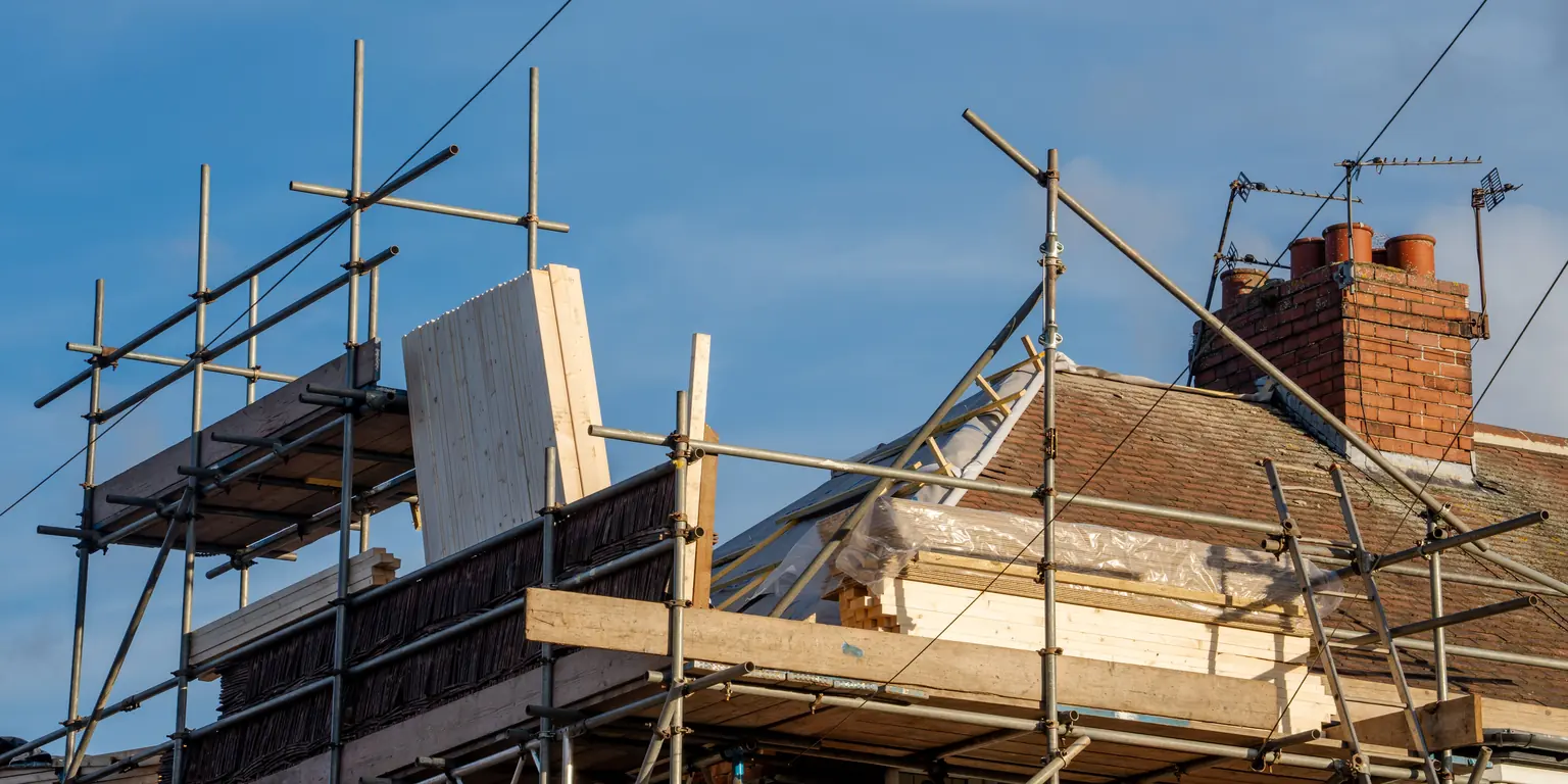 House extension under construction with scaffolding to the rear elevation
